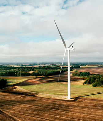 Aerial view of wind turbines spread across an agricultural landscape
